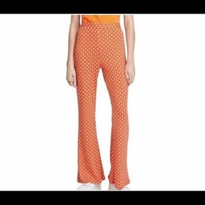 Orange bellbottoms extra small pants with white and purple flowers